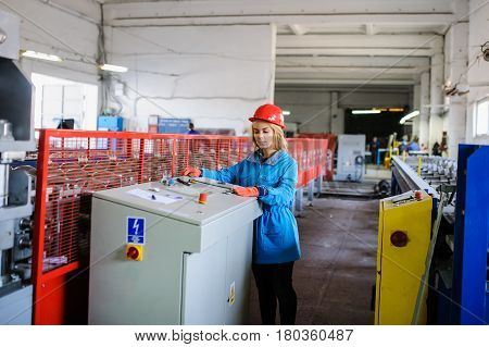 Woman In Red Safety Helmet Work As Industrial Worker