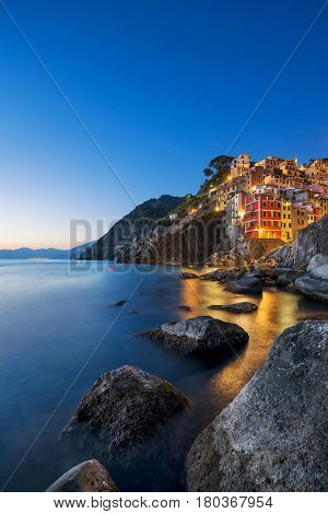 Riomaggiore town cape and sea landscape at sunset. Seascape in Cinque Terre National Park Liguria Italy Europe. Long Exposure