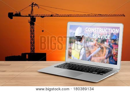 Laptop showing construction service concept for engineer with foreman worker checking construction site for new Infrastructure construction project