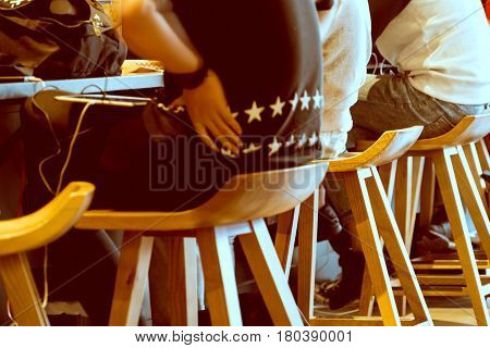 Boy group sitting on the wooden chair in coffee shop