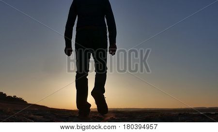 freedom. Man stands on cliff sunset silhouette hand in lifestyle the sides