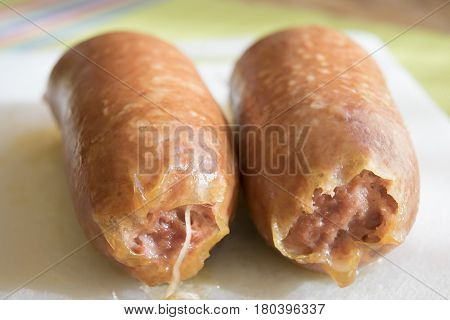 Italian cotechino or gelatinous pork sausage in a natural casing