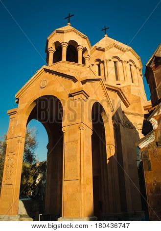 Photo of the Katoghike Holy Mother of God Church and Saint Anna Church. Armenian architecture. Yerevan City center, Armenia. Religious background. Travel concept. Vertical. Arches