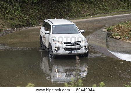 Lao Cai, Vietnam - Mar 17, 2017: Toyota Fortuner 2017 SUV in a test drive for ability on multi terrains in the far north of Vietnam.