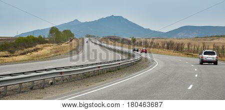 Road tThe road to the mountainous terrain in Kazakhstan. View through the windshield of the car.o the mountains