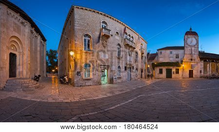 TROGIR CROATIA - SEPTEMBER 28 2015: Saint Sebastian Church and Trg Ivana Pavla II in Trogir Croatia. Trogir was founded in the 3rd century BC by Greek colonists from the island of Vis.