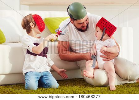 Father With Sons Playing In War Games At Home
