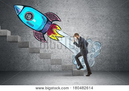 Side view of businessman climbing concrete stairs in interior with launching rocket sketch. Startup cpncept. 3D Rendering