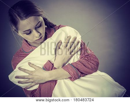 Sad Depressed Girl In Bed Gripping Pillow