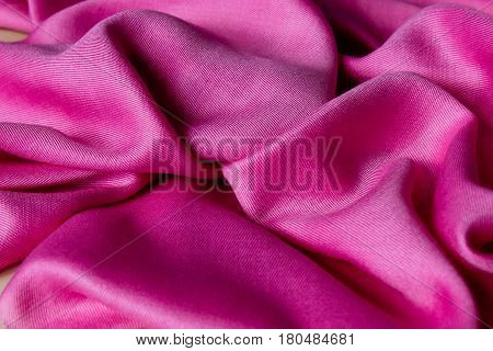 Abstract pink fabric with folds and waves  background