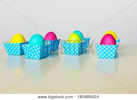 Painted  in different colors  Easter eggs on light background.