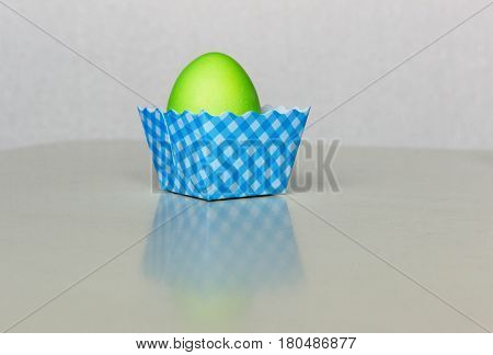 Painted  in green color  Easter egg on white background.