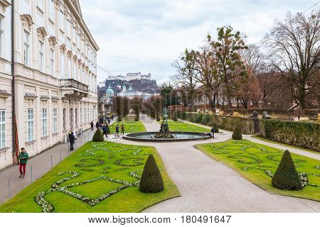 Salzburg, Austria - December 25, 2016: Green flowerbed garden and Hohensalzburg Festung in Salzburg, Austria