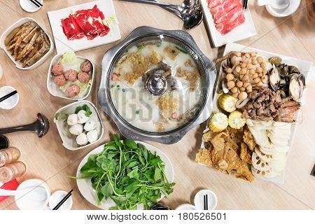 Traditional Chinese Steamboat Or Hotpot With Delicious Food Spread