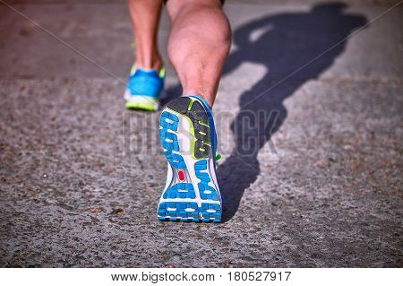 Running athlete during training outdoors in the summer on a sunny day.
