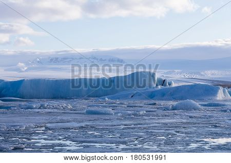Frozen winter lake breaking with blue sky background Iceland natural landscape background