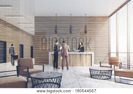 Front view of a ligth wooden reception counter standing in an office lobby with marble floor and armchairs. There are people in it. 3d rendering. Double exposure