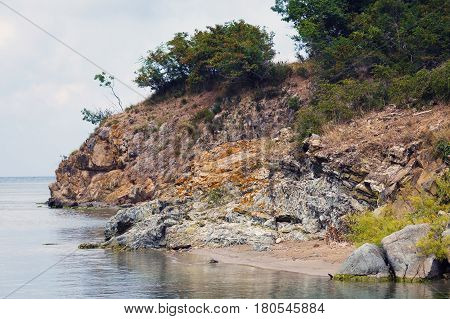 Rock on the shore of the Black Sea. Scenic seascape. Rocky cliff and sea.
