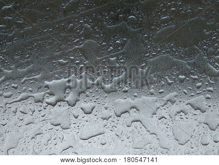 Drops Of Rain Water On Metal Surface Background - Close up shiny metal surface covered in water droplets after the rain, raindrop abstract texture background photo.