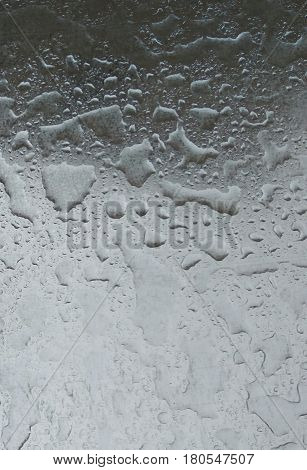 Drops Of Rain Water On Metal Surface Background - Close up shiny metal surface covered in water droplets after the rain, raindrop abstract texture background photo.