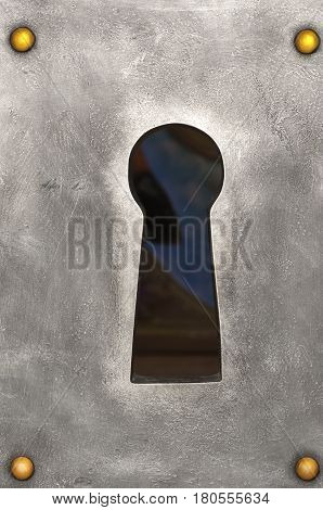 large keyhole in the metal plate with golden nails, closeup