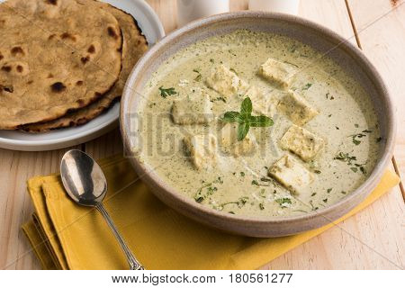 methi malai paneer or Creamy Fenugreek & Paneer Curry, popular north indian recipe prepared using milk cream, methi and paneer or cottage cheese, served with roti/paratha, selective focus