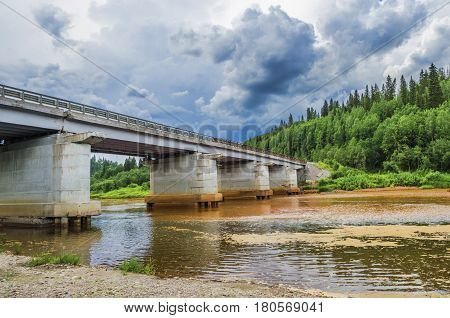 The bridge over the river. The river Vilva polluted in the result of human activities