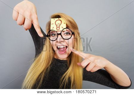 Woman Having Light Bulb Mark On Forehead Thinking