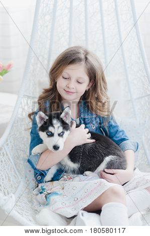 Little Girl Hugging A Puppy Husky