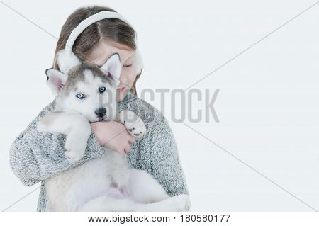 Little Girl Hugging A Puppy Husky