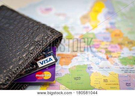 Mar 18 2017. Bangkok Thailand. Credit crad visa and master card put on world map paper