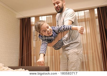 Young father with son having fun at home