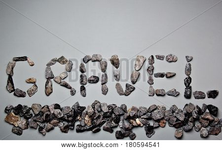 Letters From Gravel On Gray Background. Wrote Gravel.copy Space