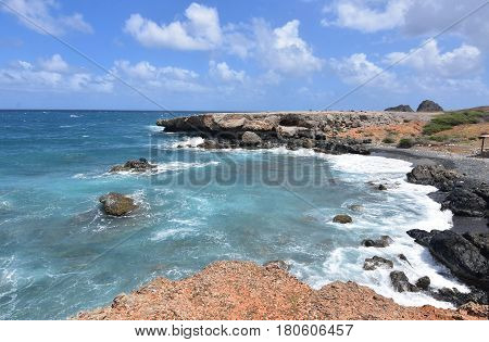 Pretty black sandstone beach on the Island of Aruba.