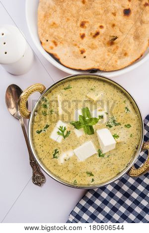 methi malai paneer or Creamy Fenugreek & Paneer Curry, popular north indian recipe prepared using milk cream, methi and paneer or cottage cheese, served with roti/paratha, selective focus