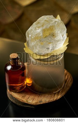 Close-up of a fresh branded alcoholic cocktail with ice and cognac and smoke in a Whiskey glass on a wooden birch bar counter. Concept of alcoholic and non-alcoholic bar beverage.