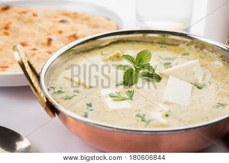 methi malai paneer or Creamy Fenugreek & Paneer Curry, popular north indian recipe prepared using milk cream, methi and paneer or cottage cheese, served with roti/paratha, selective focus