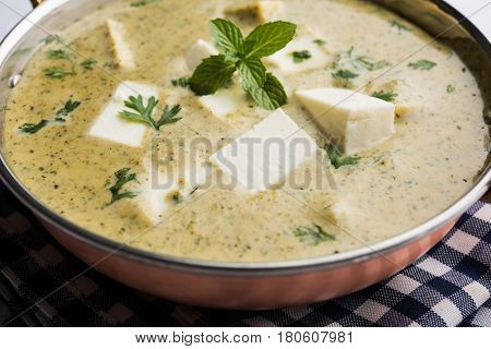 methi malai paneer or Creamy Fenugreek & Paneer Curry, popular north indian recipe prepared using milk cream, methi and paneer or cottage cheese, served with roti/paratha, selective focus