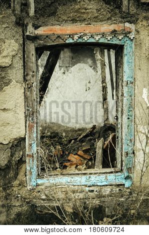 View of an old abandoned log house, finished with a plaster in a village.