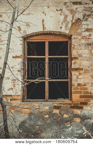 View of an old abandoned log house, finished with a plaster in a village.