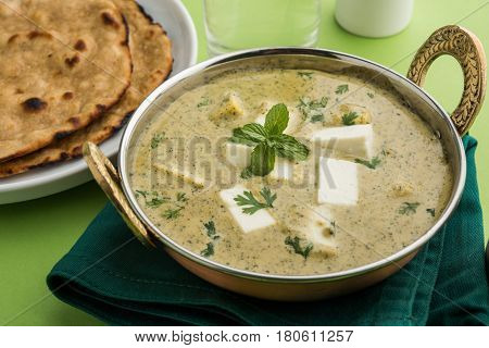 methi malai paneer or Creamy Fenugreek & Paneer Curry, popular north indian recipe prepared using milk cream, methi and paneer or cottage cheese, served with roti/paratha, selective focus