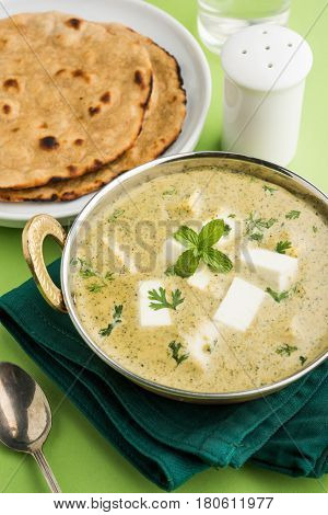 methi malai paneer or Creamy Fenugreek & Paneer Curry, popular north indian recipe prepared using milk cream, methi and paneer or cottage cheese, served with roti/paratha, selective focus