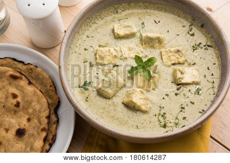 methi malai paneer or Creamy Fenugreek & Paneer Curry, popular north indian recipe prepared using milk cream, methi and paneer or cottage cheese, served with roti/paratha, selective focus