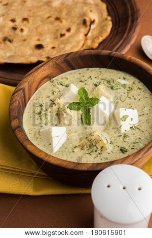 methi malai paneer or Creamy Fenugreek & Paneer Curry, popular north indian recipe prepared using milk cream, methi and paneer or cottage cheese, served with roti/paratha, selective focus