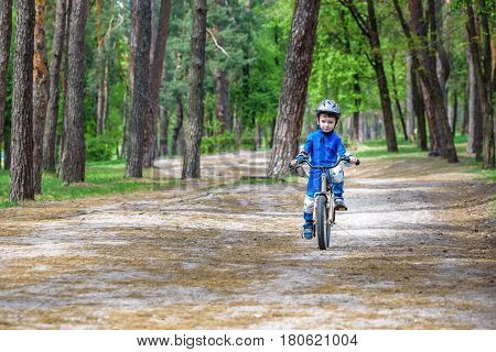 Happy Cute Blond Kid Boy Having Fun His First Bike On Sunny Summ