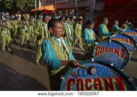ORURO, BOLIVIA - FEBRUARY 26, 2017: Band of a Morenada dance group in colourful outfits parading through the mining city of Oruro on the Altiplano of Bolivia during the annual Oruro Carnival.