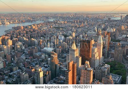New York City rooftop view with downtown Manhattan skyscrapers and urban cityscape.