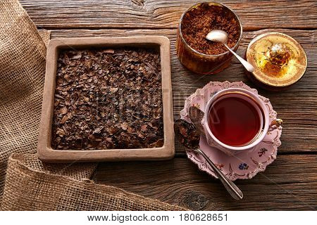 Bancha tea served pink vintage cup on wooden table board