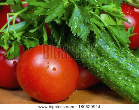 The fresh vegetables on the wooden table close up