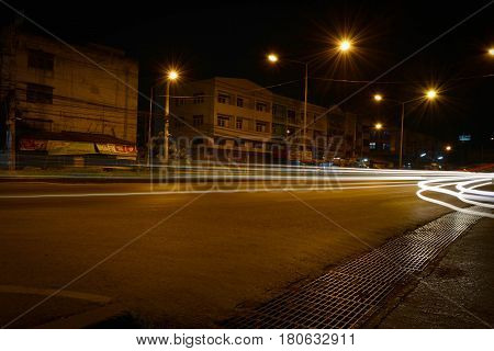 The light in the night with road and light pole.